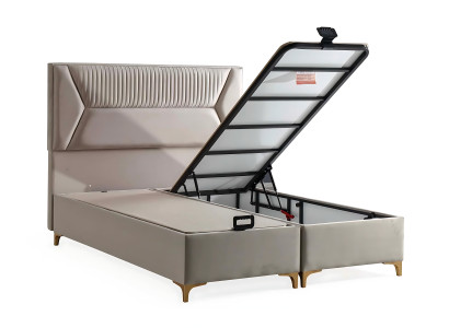 Posteľ v béžovej farbe s vankúšom z tkaniny a dreva