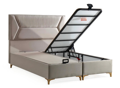 Posteľ v béžovej farbe s vankúšom z tkaniny a dreva