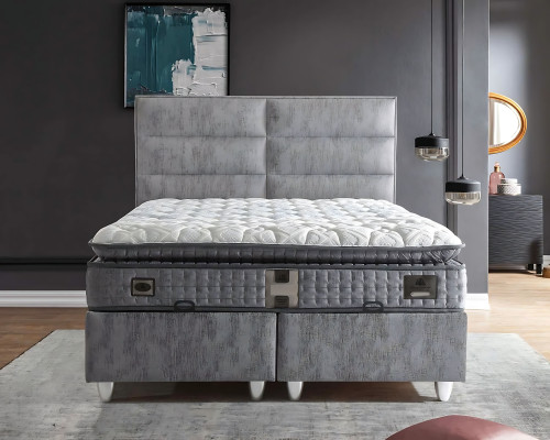 Posteľ v modernom sivom textile s matracom